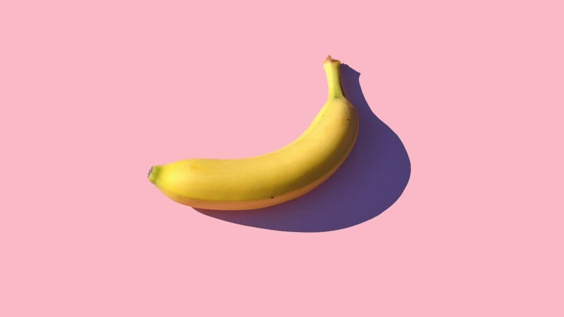 riped banana on pink surface